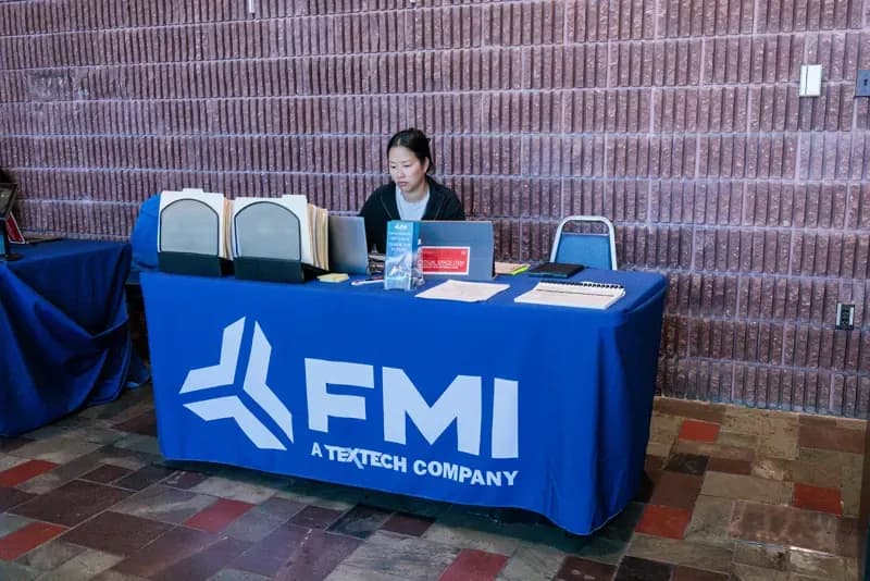 FMI recruiter at an FMI-branded table at a hiring event