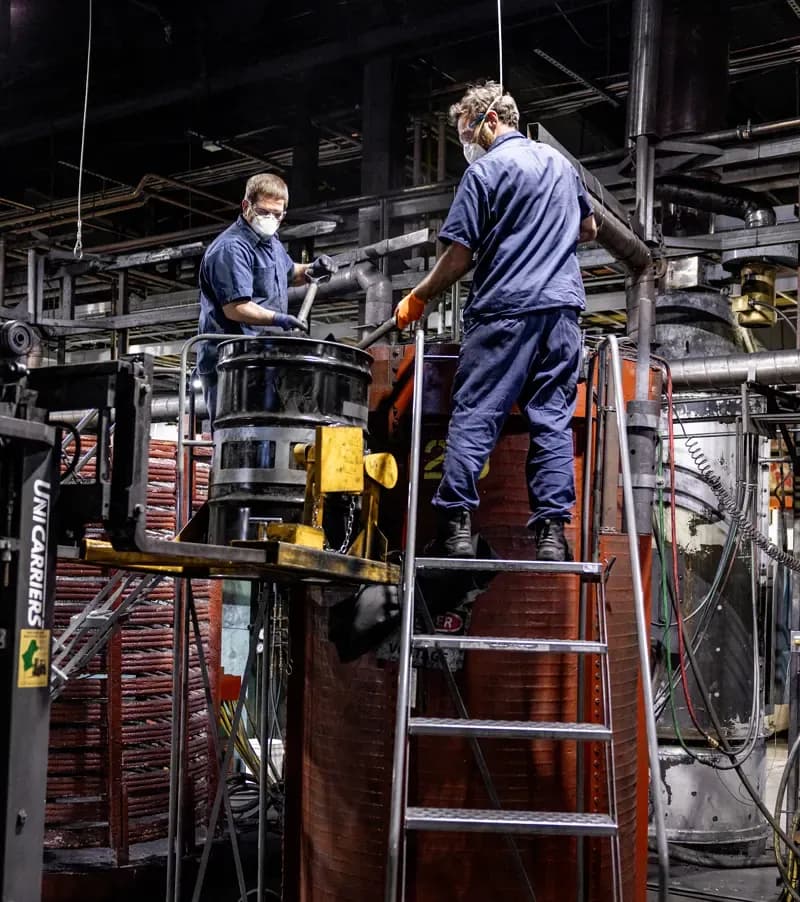 Production operators working on equipment on the FMI production floor